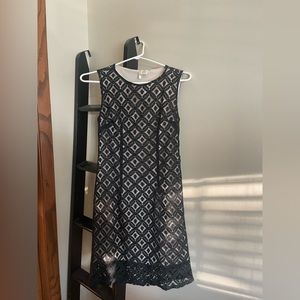 Black lace short dress worn tan shift dress underneath